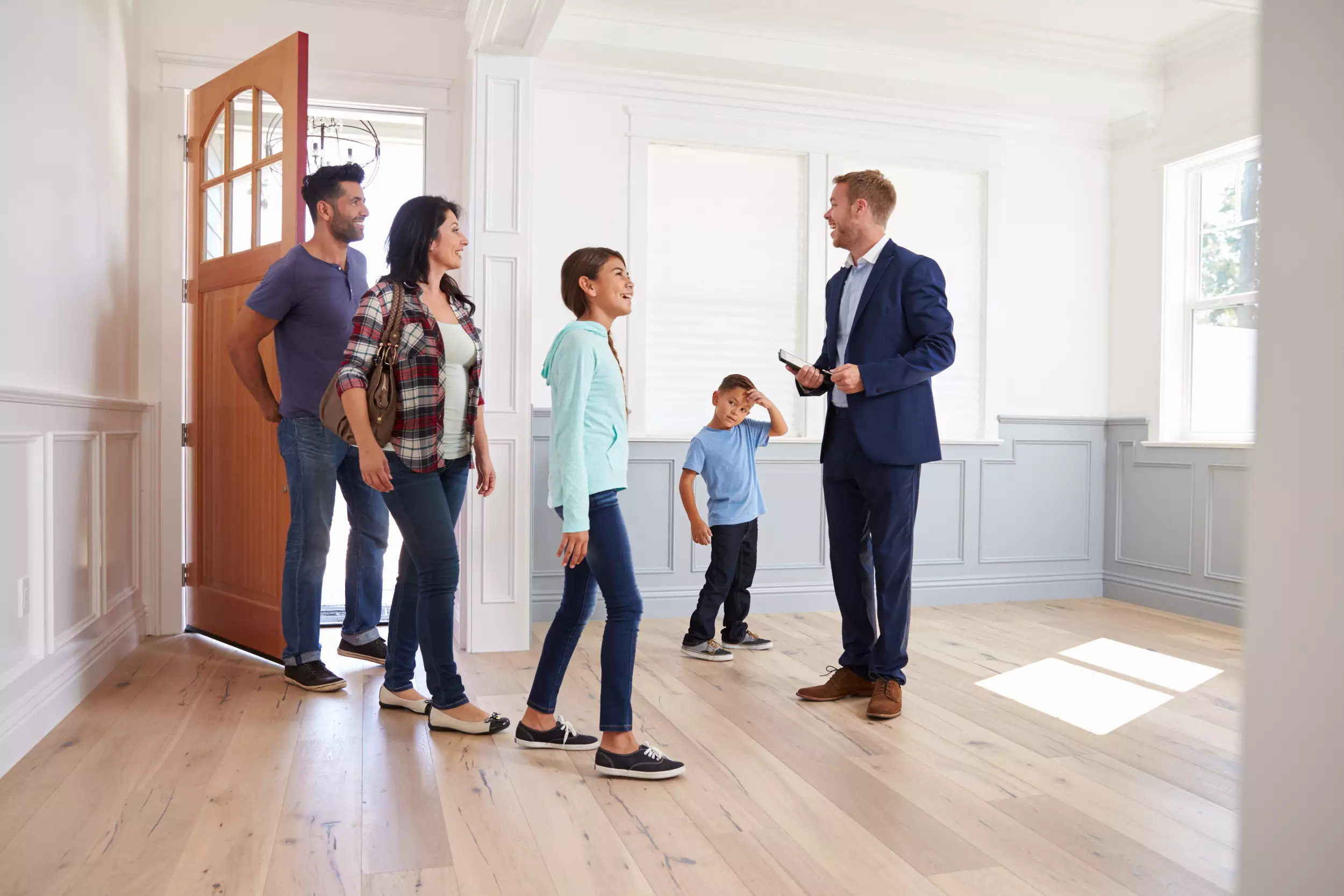 A realtor showing a family a new home